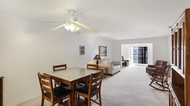 3763 Lake Bayshore Dr Unit 310, Bradenton, FL 34205 - dining room with ceiling fan, carpet flooring, and a textured ceiling
