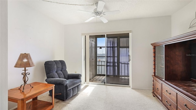 3763 Lake Bayshore Dr Unit 310, Bradenton, FL 34205 - sitting room with a textured ceiling, a ceiling fan, and light colored carpet