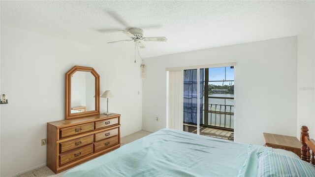 3763 Lake Bayshore Dr Unit 310, Bradenton, FL 34205 - bedroom featuring light carpet, access to exterior, ceiling fan, and a textured ceiling
