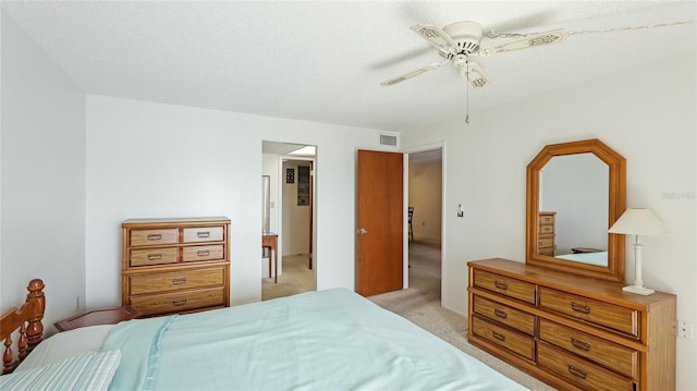 3763 Lake Bayshore Dr Unit 310, Bradenton, FL 34205 - bedroom featuring light carpet, visible vents, a ceiling fan, and a textured ceiling