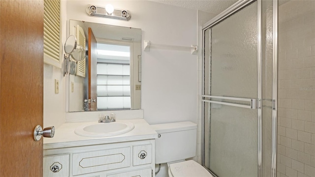 3763 Lake Bayshore Dr Unit 310, Bradenton, FL 34205 - full bath featuring toilet, vanity, a shower with door, and a textured ceiling
