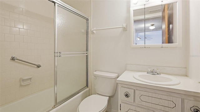 3763 Lake Bayshore Dr Unit 310, Bradenton, FL 34205 - bathroom featuring visible vents, bath / shower combo with glass door, toilet, and vanity