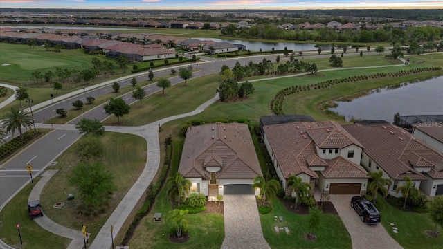 aerial perspective of suburban area featuring a nearby body of water and a golf club