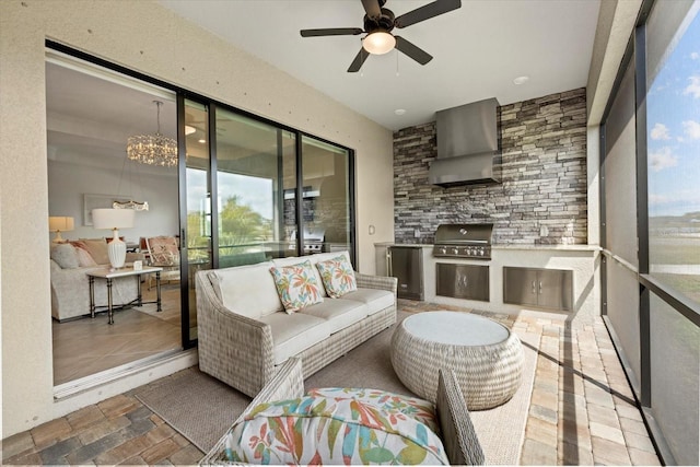 sunroom featuring exterior kitchen, ceiling fan, and an outdoor living space