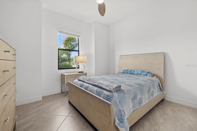 bedroom with light tile patterned floors, baseboards, and ceiling fan