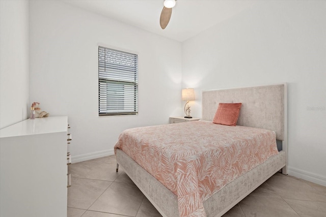 bedroom featuring tile patterned flooring, baseboards, and a ceiling fan
