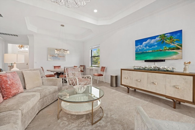 living room featuring ornamental molding, a tray ceiling, a chandelier, and recessed lighting