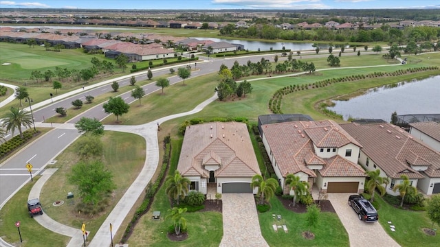aerial perspective of suburban area featuring a nearby body of water and a golf club