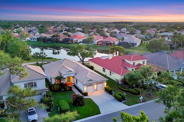 bird's eye view featuring a water view and a residential view