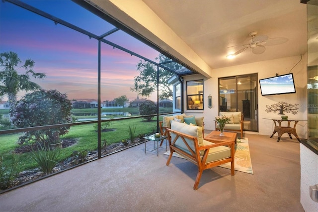 sunroom / solarium featuring ceiling fan