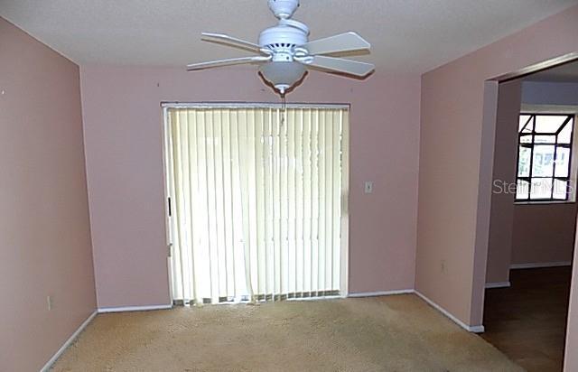 6309 35th Ave W, Bradenton, FL 34209 - carpeted spare room with baseboards and a ceiling fan