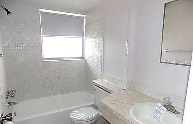 6309 35th Ave W, Bradenton, FL 34209 - bathroom with bathtub / shower combination, toilet, and vanity