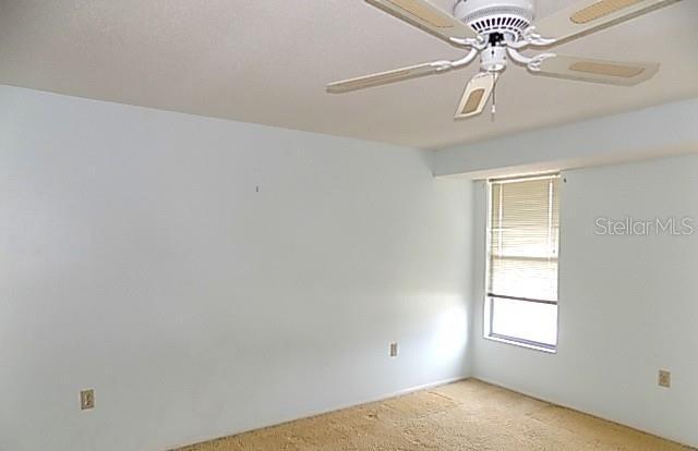 6309 35th Ave W, Bradenton, FL 34209 - empty room featuring light colored carpet and ceiling fan