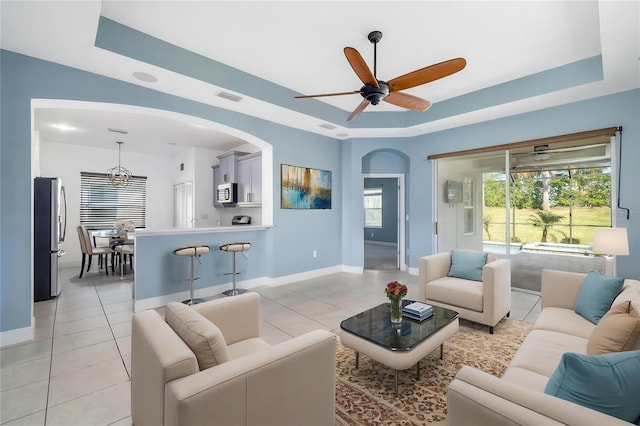 4162 Deep Creek Ter, Parrish, FL 34219 - living room featuring a raised ceiling, light tile patterned floors, baseboards, and visible vents