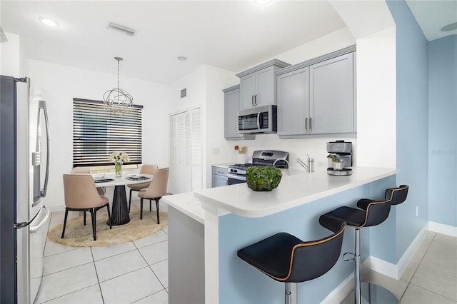 4162 Deep Creek Ter, Parrish, FL 34219 - kitchen featuring visible vents, light countertops, appliances with stainless steel finishes, and light tile patterned flooring