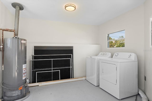 clothes washing area with washing machine and clothes dryer, laundry area, and gas water heater