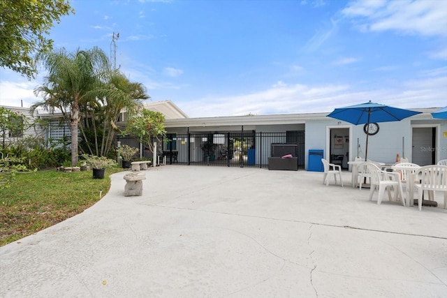 view of building exterior featuring fence and a carport