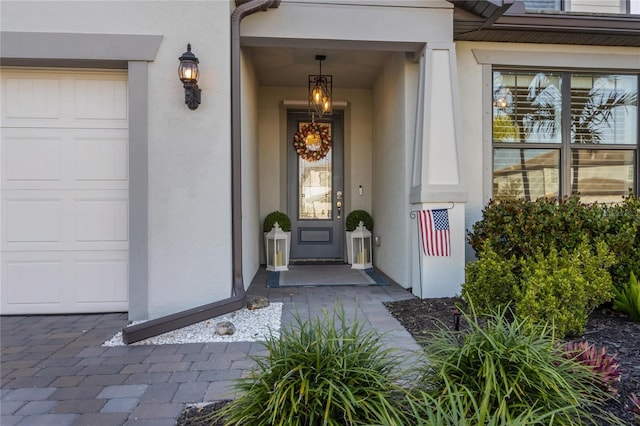 entrance to property featuring stucco siding
