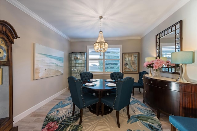 dining space featuring crown molding, baseboards, and a chandelier