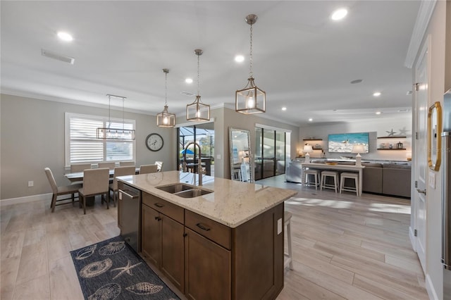 kitchen featuring a sink, recessed lighting, open floor plan, stainless steel dishwasher, and visible vents