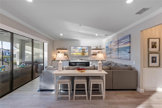 living area featuring recessed lighting, ornamental molding, and visible vents