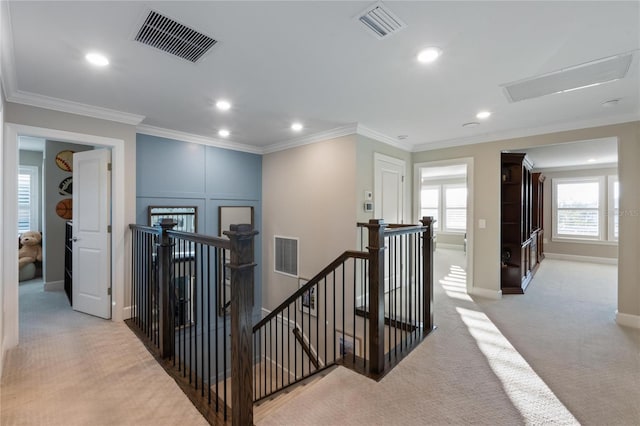 corridor featuring visible vents, carpet flooring, and an upstairs landing