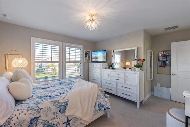 bedroom with multiple windows, visible vents, baseboards, and light carpet