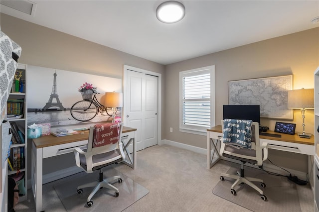 office space with light carpet, baseboards, and visible vents