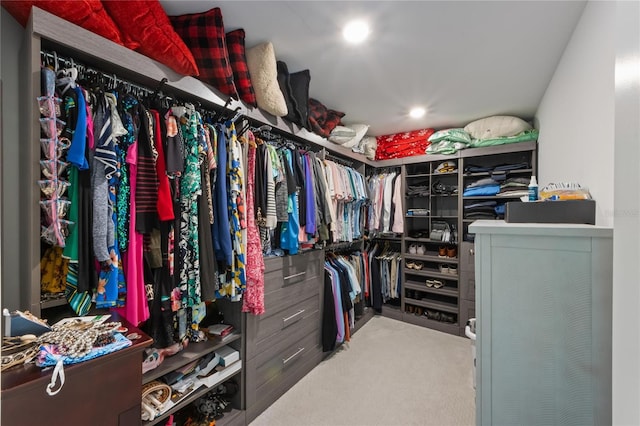 walk in closet with carpet