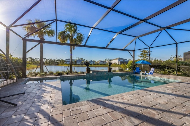 pool with a patio area, a water view, and glass enclosure