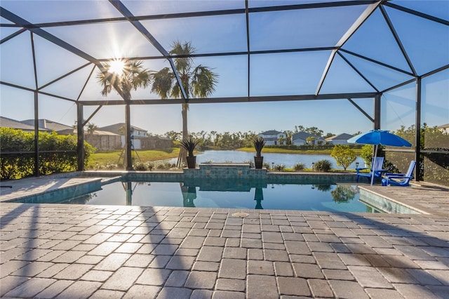 pool with a water view, a patio area, glass enclosure, and a residential view