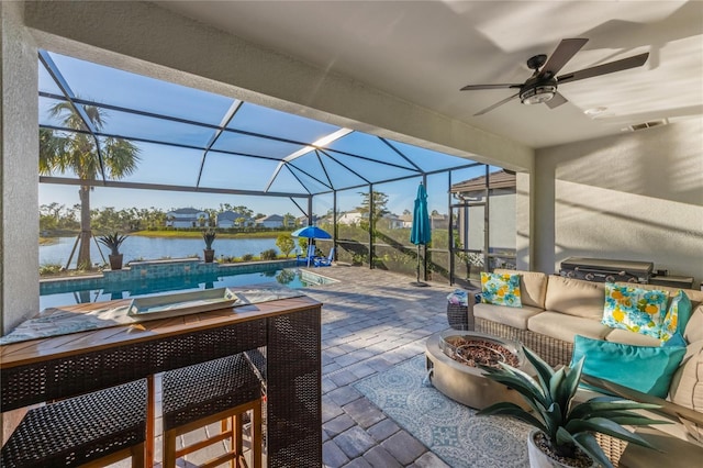view of patio / terrace with a hot tub, an outdoor pool, ceiling fan, an outdoor living space with a fire pit, and a water view