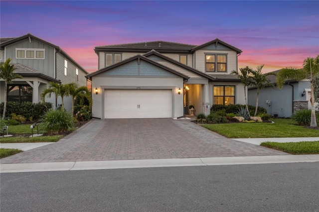 traditional home featuring an attached garage, a front yard, and driveway