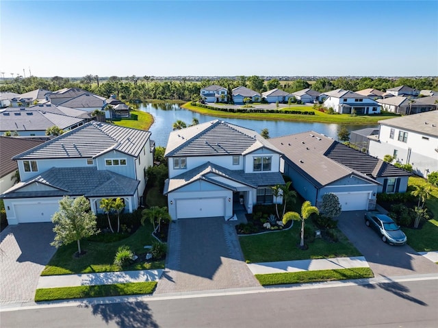 drone / aerial view featuring a water view and a residential view
