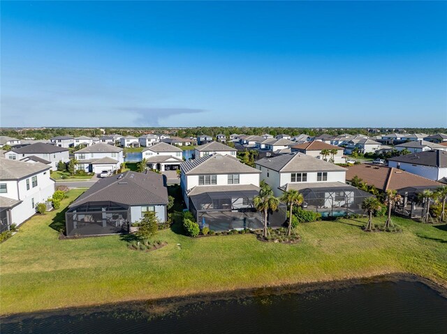 birds eye view of property with a water view and a residential view