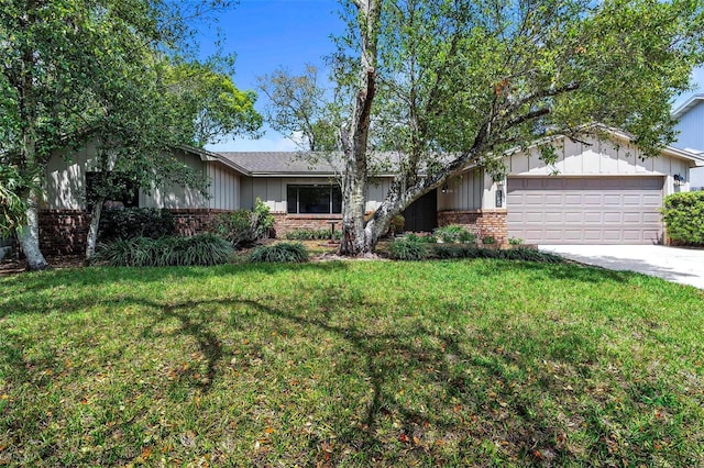 ranch-style home featuring a garage, a front yard, concrete driveway, and brick siding