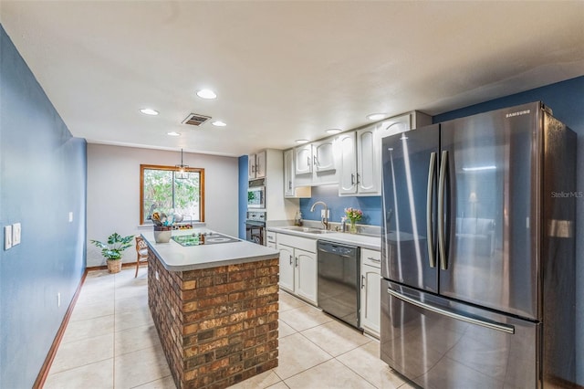 kitchen with light tile patterned floors, visible vents, a sink, and black appliances
