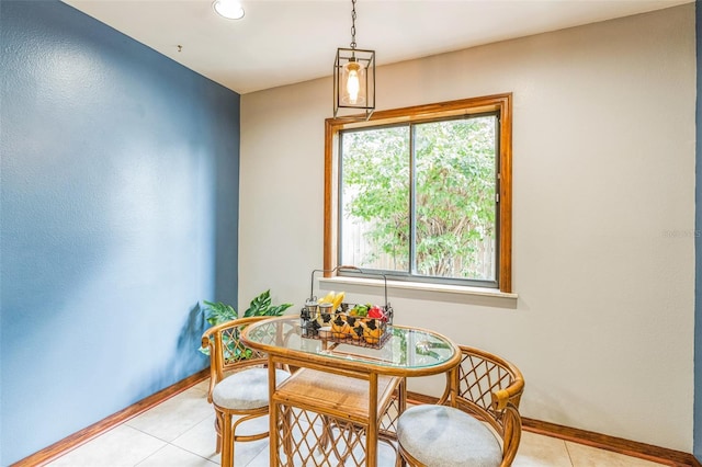 dining room with light tile patterned flooring and baseboards