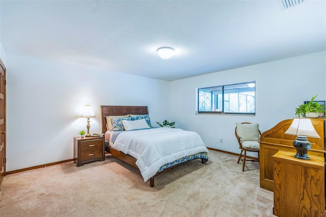 bedroom featuring visible vents, baseboards, and light carpet