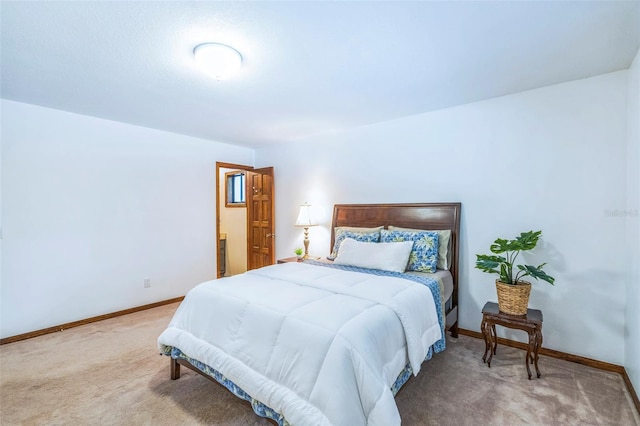 bedroom with baseboards and carpet floors