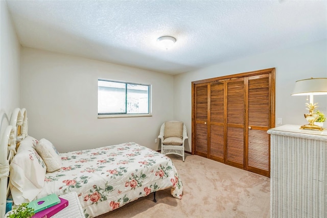 carpeted bedroom featuring a closet and a textured ceiling