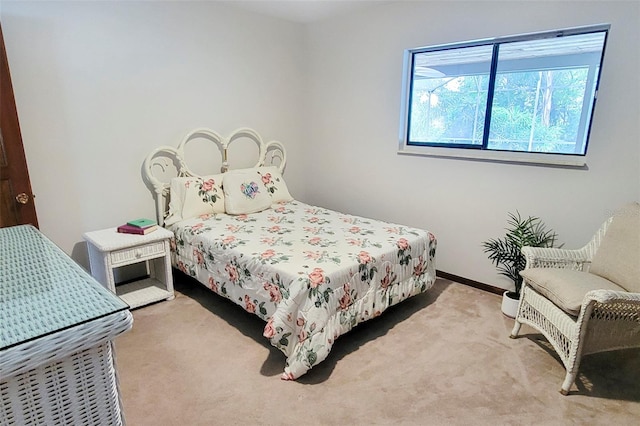 bedroom with carpet flooring and baseboards