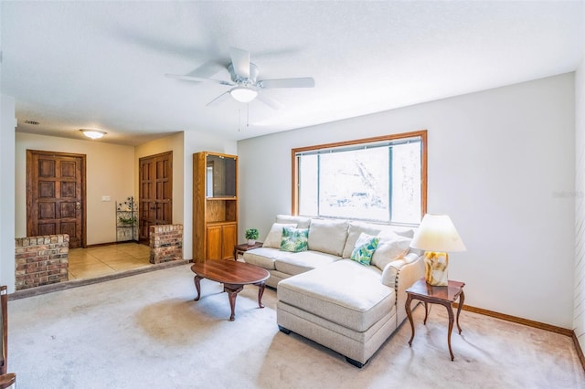 living room featuring carpet flooring, baseboards, and a ceiling fan