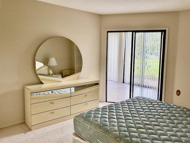 bedroom featuring carpet floors, access to outside, and a textured ceiling