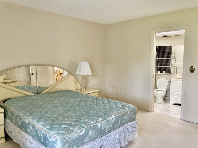 carpeted bedroom featuring ensuite bathroom