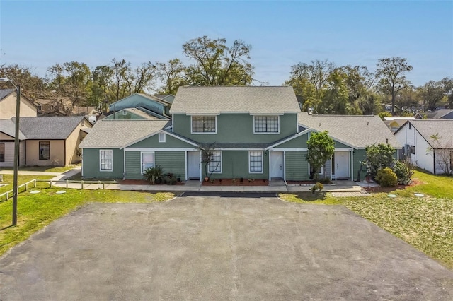 1236 Dovehill Dr, Apopka, FL 32703 - view of front of house featuring asphalt driveway, stucco siding, a front lawn, a residential view, and a shingled roof