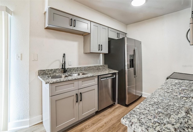 1236 Dovehill Dr, Apopka, FL 32703 - kitchen featuring appliances with stainless steel finishes, gray cabinets, and light wood-type flooring