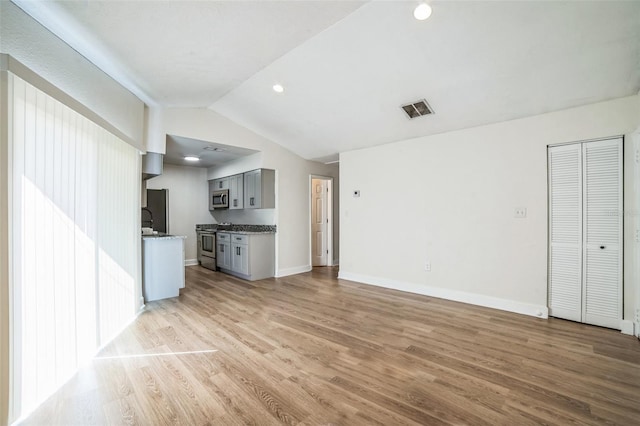1236 Dovehill Dr, Apopka, FL 32703 - unfurnished living room with vaulted ceiling, light wood-type flooring, and recessed lighting