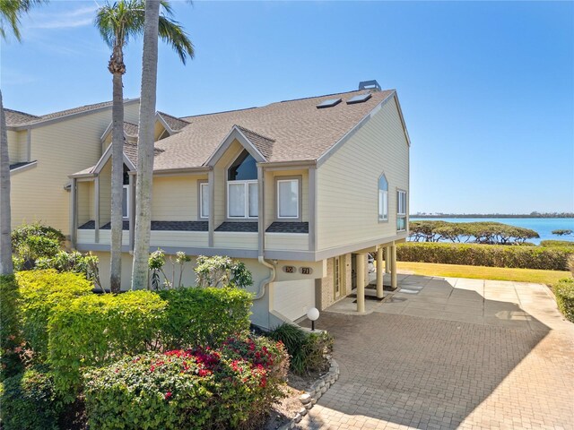 71 Tidy Island Blvd, Bradenton, FL 34210 - view of front facade with a water view and roof with shingles