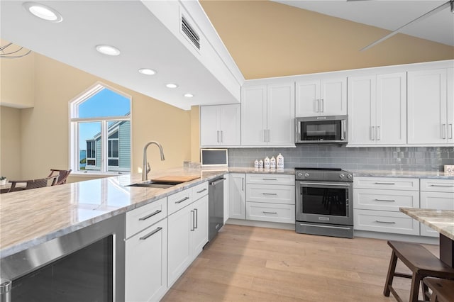 71 Tidy Island Blvd, Bradenton, FL 34210 - kitchen with a sink, stainless steel appliances, wine cooler, and lofted ceiling